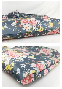 Detail of waterproof floral shopping bag fabric with pink roses and cross-grain texture