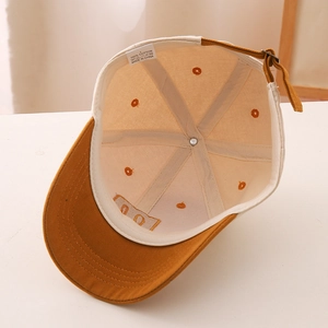 Close-up of cotton baseball cap interior showing the 100% cotton label and sweatband