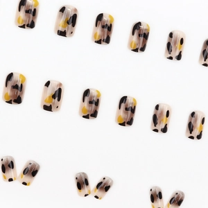 Short squoval leopard print press-on nails with amber texture in brown and yellow tones