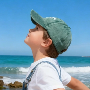 Kids vintage dinosaur skeleton baseball cap in forest green with white embroidery