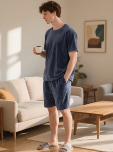 Men's navy blue velvet leisure set with short sleeves and shorts in a home setting