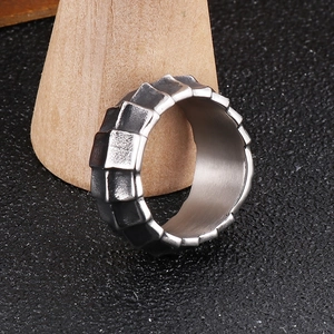 Macro view of men's stainless steel dragon body ring with industrial tiered design