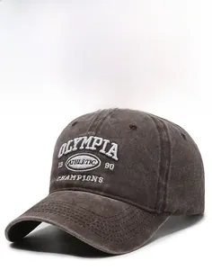 Detail view of vintage dark brown baseball cap featuring white 3D athletic embroidery