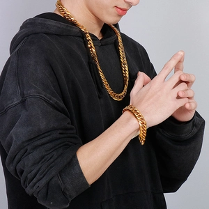 Detailed view of a men's gold Cuban link necklace and matching bracelet set