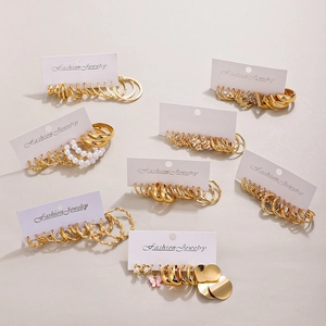 Golden alloy geometric earring set with hoops, pearls and butterfly charms on display cards