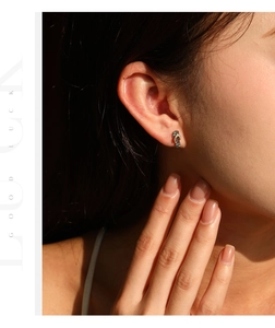 Close-up of S925 silver flip-flop earring with colorful zircon stones on model's ear