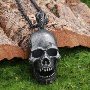 Gothic skull pendant necklace with vintage silver finish on green moss and wood