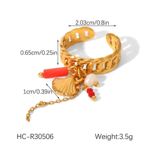 Detail view of gold chain ring with shell, pearl, and coral charms with dimensions