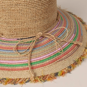 Handmade raffia sun hat with colorful rainbow stripes, fringed brim and bow detail