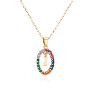 Macro shot of 18K gold plated oval pendant with rainbow zircon stones and letter I