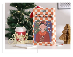 Detail of Christmas gift bag with orange checkerboard pattern and cute girl illustration
