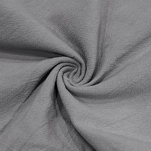 Close-up of light grey linen fabric texture showing breathable weave and soft drapery