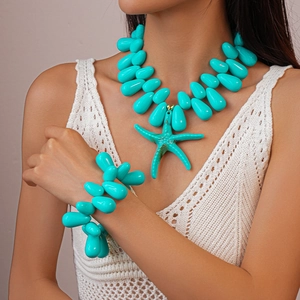 Detail of turquoise acrylic bead necklace and bracelet set with starfish pendant on model
