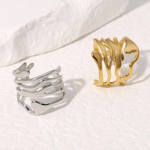 Irregular wave design wide titanium steel rings in gold and silver finish set on a stone