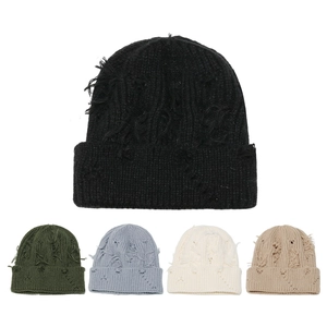 Detailed knit texture and distressed holes on beanies in multiple street style colors