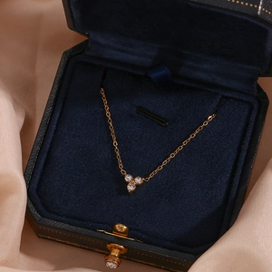 Close-up of 18K gold plated stainless steel bracelet with lotus zircon pendant in a box
