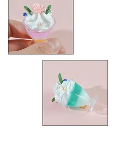 Detailed macro view of miniature sundae cup charms with realistic cream and rose topper