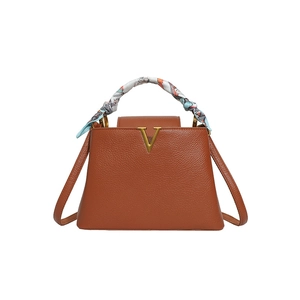 Brown leather top handle bag with metal V logo, stylish twilly scarf wrapped handle and strap.