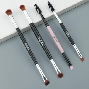 Detail of dual-ended makeup brushes with soft bristles for lash, eyebrow, and eyeshadow