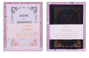 Macro shot of black and white Book of Answers notebook set with gold stamped foil details