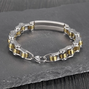 Detail of two-tone gold and silver bicycle chain bracelet with blank metal plate
