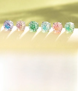 Macro shot of 6mm and 8mm zircon titanium steel studs with colorful round cut gems
