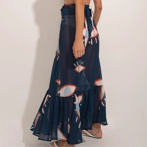 Detail of navy blue sheer beach wrap dress with eye prints and ruffled hemline