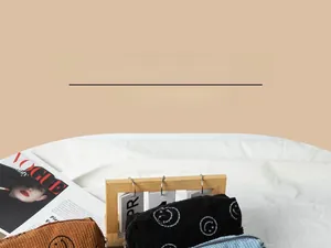 Detailed corduroy texture of makeup bags with smiley faces in brown, black, and light blue