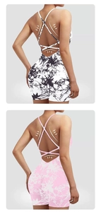 Detail of cross-back straps and open back design on marble tie-dye yoga playsuit