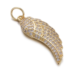 Close-up of golden wing pendant with micro-pave cubic zirconia on white background
