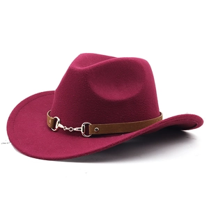 Detail of wine red wool cowboy hat featuring a brown band and metal horsebit buckle