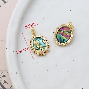 Detail of 14k gold-filled oval abalone shell pendant with rose motif and 16x25mm dimensions