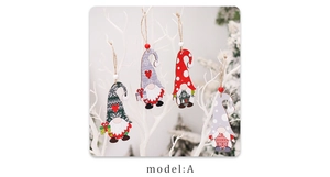 Detail of wooden Christmas gnome hanging ornaments with ropes on white branches