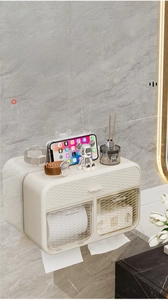 Detail view of wall-mounted cream tissue box with ripple texture and top shelf