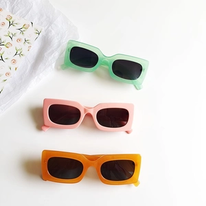 Three pairs of vintage rectangle sunglasses in green, pink, and orange on white background