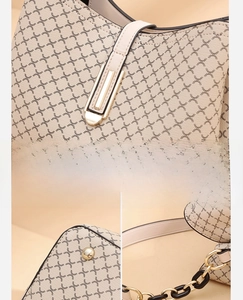 Close-up of vintage bucket bag featuring geometric cross patterns and gold chain detail