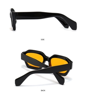 Detail view showing the side and back of black chunky polygon sunglasses with orange lenses