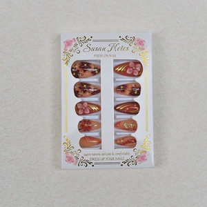 Set of 24 almond press-on nails with 3D embossed pink flowers and gold foil accents