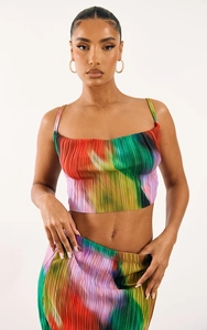 Detailed view of the pleated fabric texture and artistic colorful print on a two-piece set