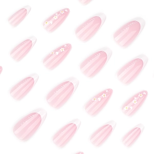 Pink gradient almond press-on nails with white French tips and delicate floral heart patterns