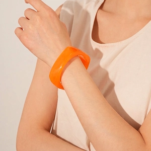 Minimalist orange resin geometric bangle with transparent finish for luxury fashion