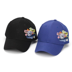 Detail of embroidered smile patch and colorful lettering on cotton baseball caps