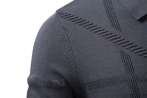 Detailed close-up of charcoal gray knit fabric shoulder seam on a men's polo sweater