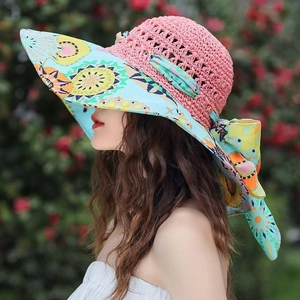 Detail of handmade knit sun hat with floral brim and large decorative back bow