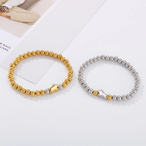 Minimalist elastic steel bead bracelets in gold and silver with pig pendant