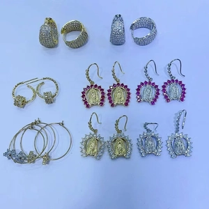 Macro detail of 18K gold and silver plated Virgin Mary pendants with pavé cubic zirconia