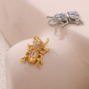 Polished beetle pendants in gold and silver finish with sparkling cubic zirconia gems
