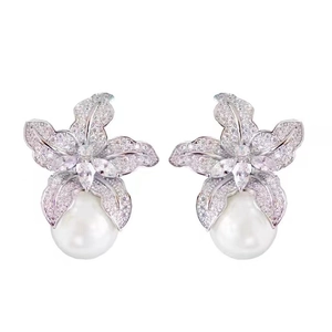Sparkling crystal lily flower earrings with white teardrop pearls and silver finish