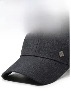 Detail of grey baseball cap showing sturdy brim and metallic side logo ornament