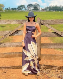Detail of bohemian long dress featuring waist cut-outs and large leaf prints in nature